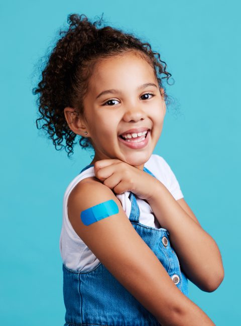 Shot of a little girl showing off a bandaid on her arm I'm a big girl now